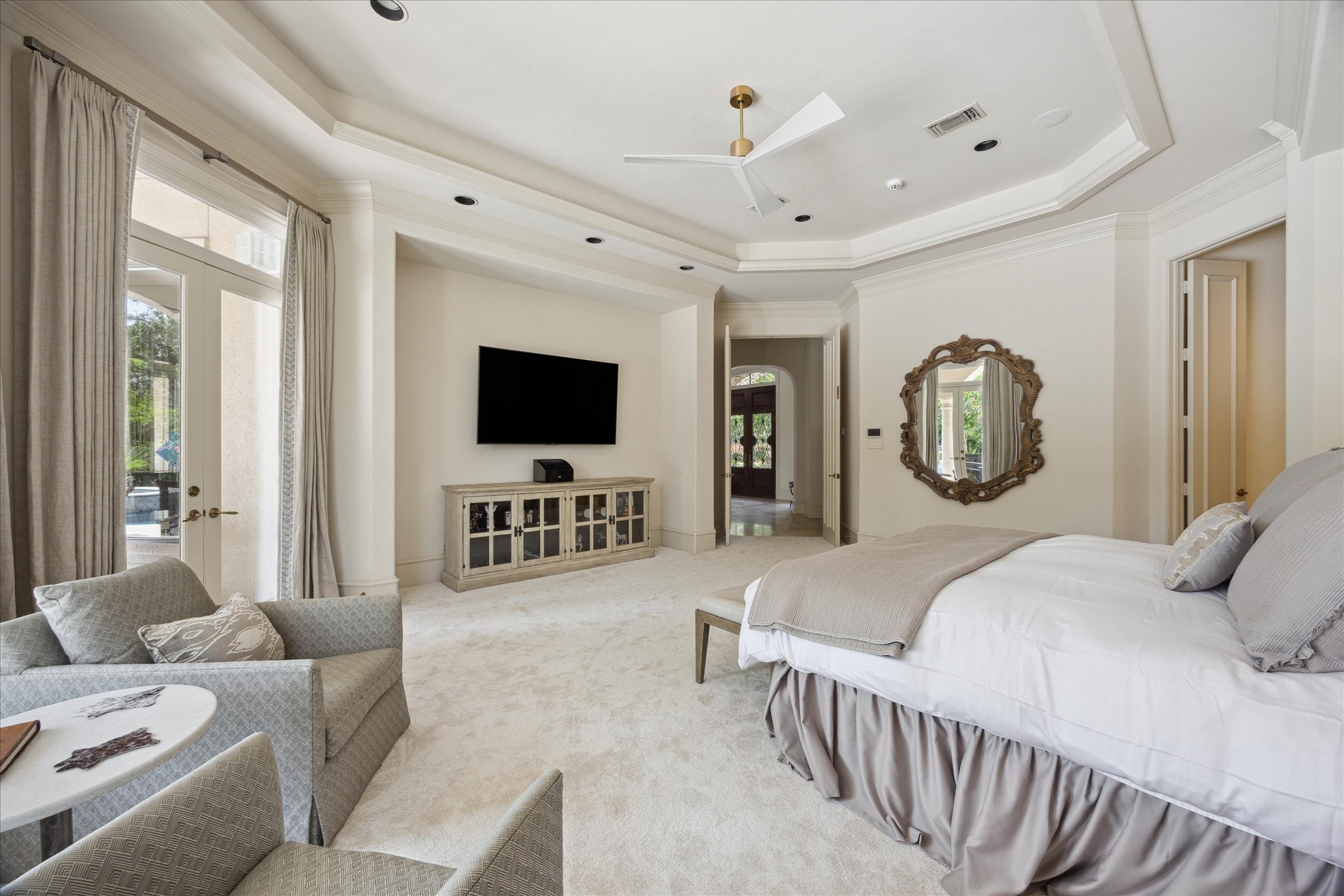 11607 Barazi Oaks Court Houston, TX 77024 - Photo 19 of 43 a bedroom with furniture and a flat screen tv