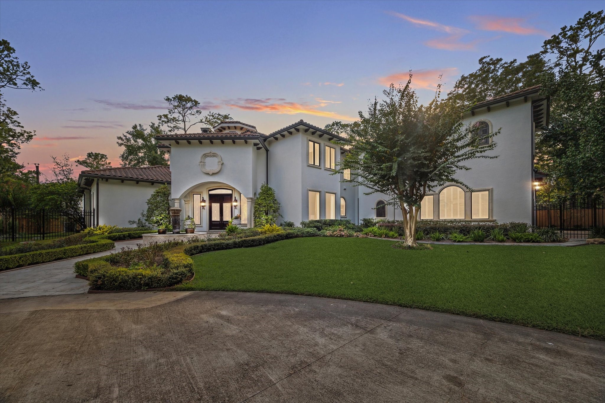 11607 Barazi Oaks Court Houston, TX 77024 - Photo 2 of 43 a front view of a house with garden