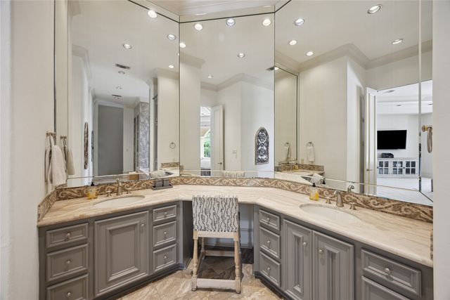 a bathroom with a granite countertop toilet sink and mirror