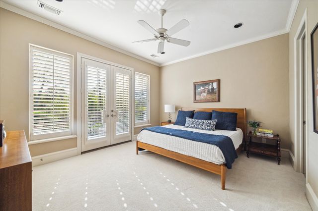 a bedroom with a bed and a wooden floor