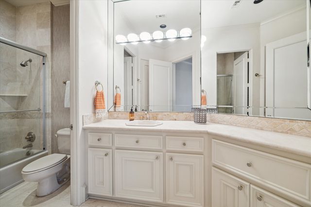 a spacious bedroom with a bed and a large window