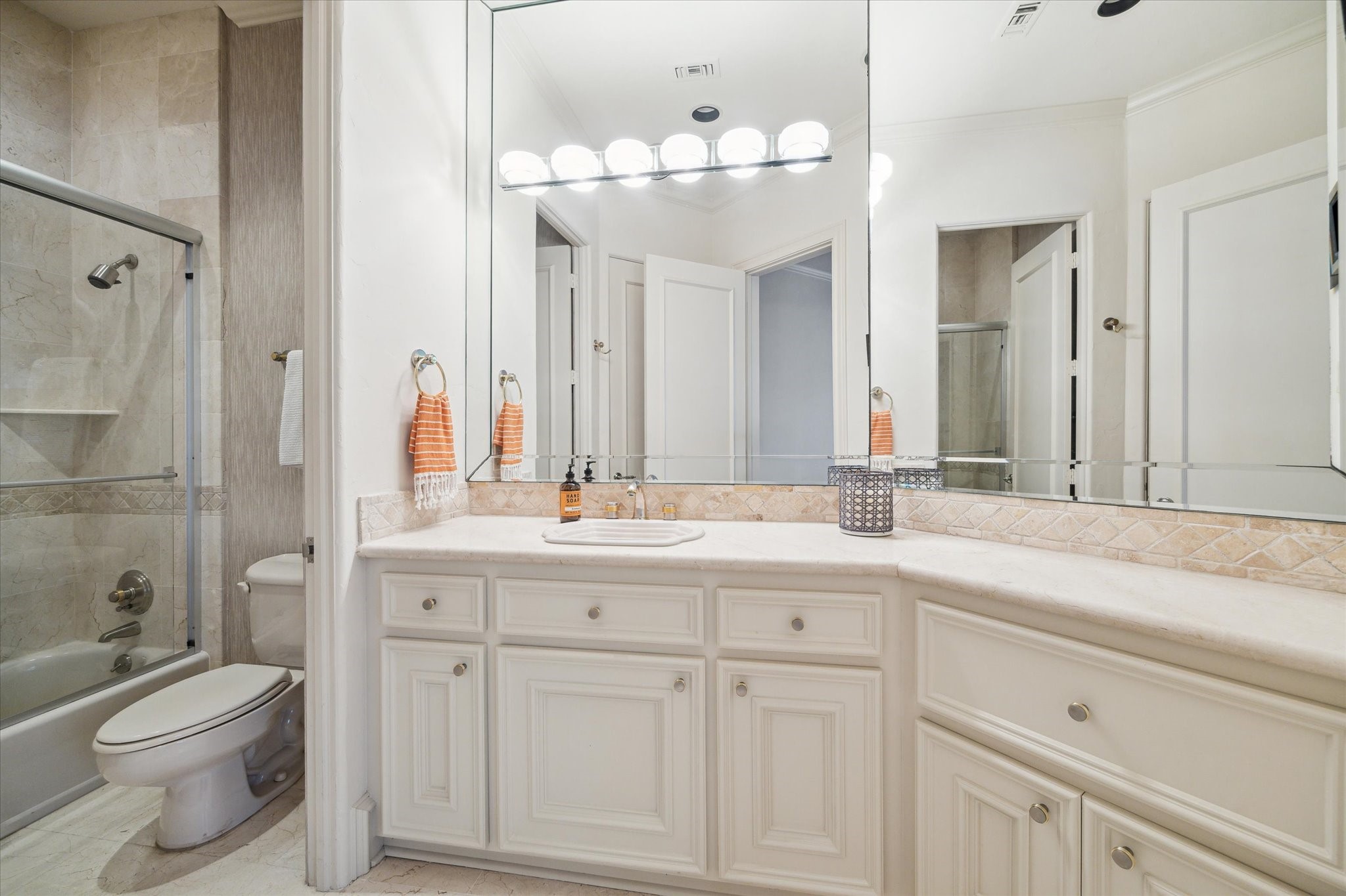 11607 Barazi Oaks Court Houston, TX 77024 - Photo 28 of 43 a bathroom with a toilet a sink a mirror and a shower
