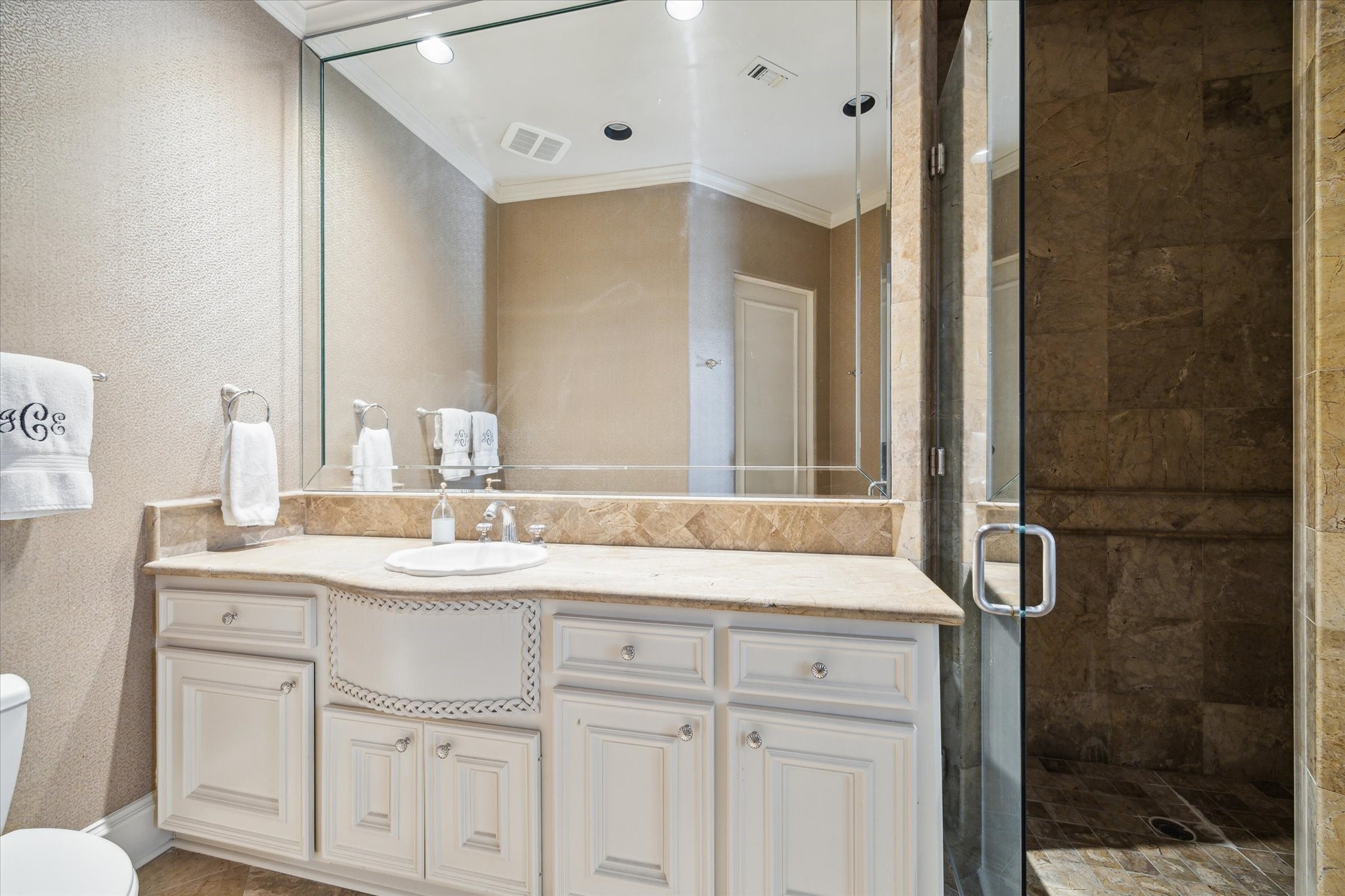 11607 Barazi Oaks Court Houston, TX 77024 - Photo 32 of 43 a bathroom with a sink and a mirror
