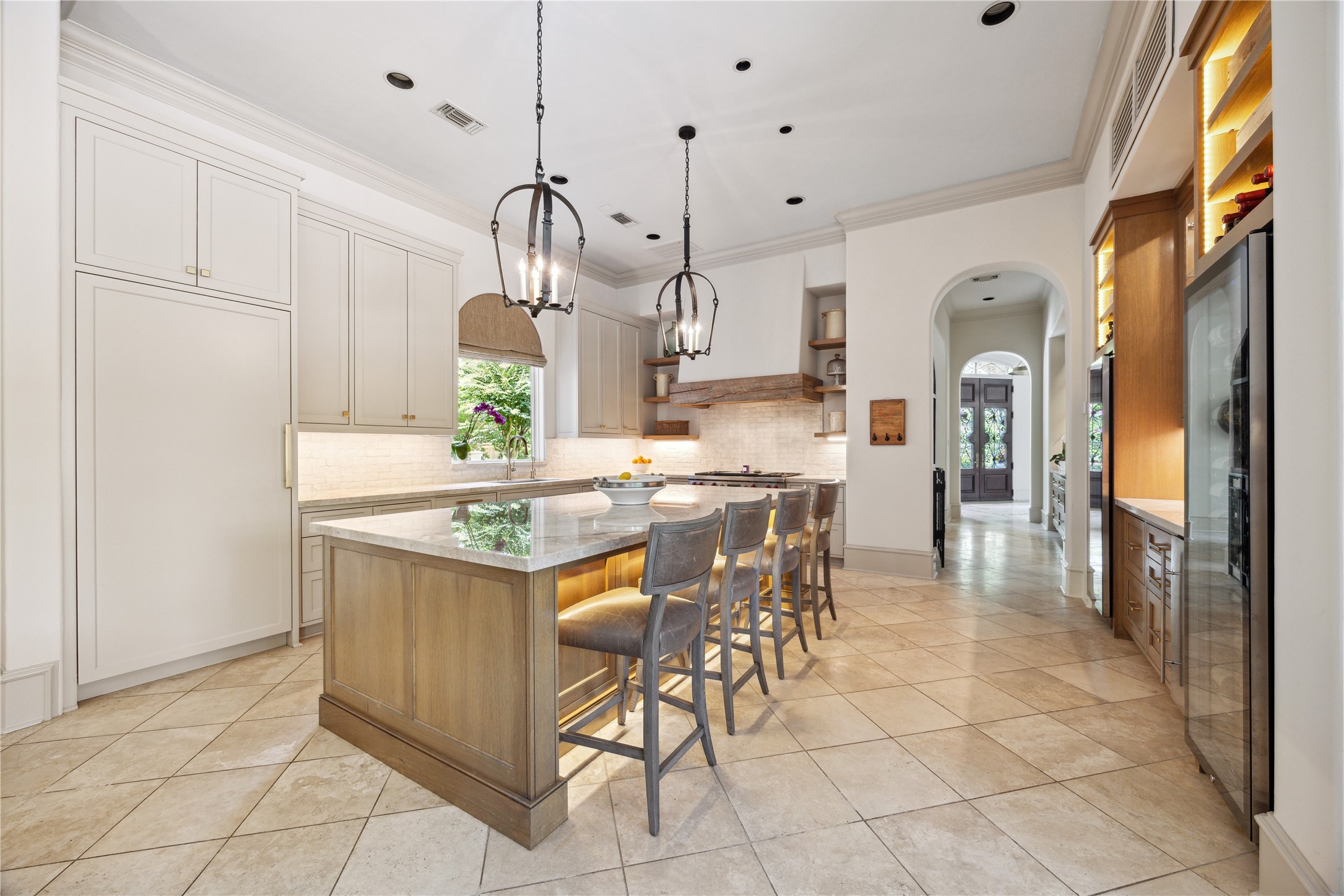 11607 Barazi Oaks Court Houston, TX 77024 - Photo 6 of 43 a kitchen with granite countertop a refrigerator a stove a dining table and chairs