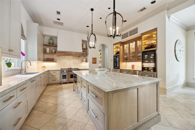 a kitchen with stainless steel appliances granite countertop a sink and cabinets