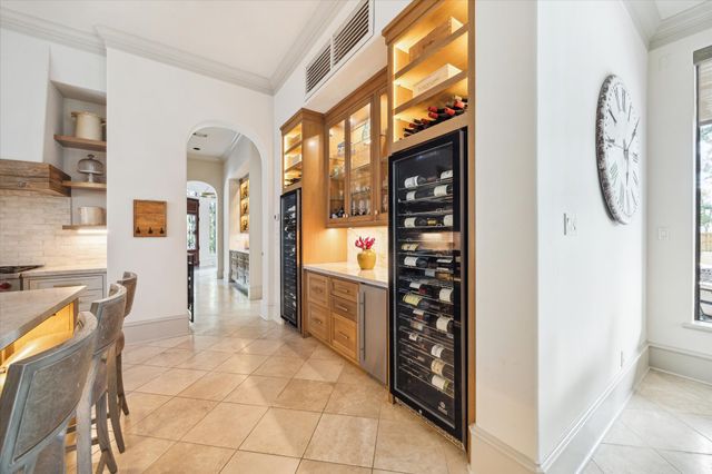 a dining room with stainless steel appliances kitchen island granite countertop a refrigerator and a wooden cabinets