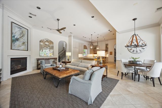 a living room with furniture a fireplace and a wall painting