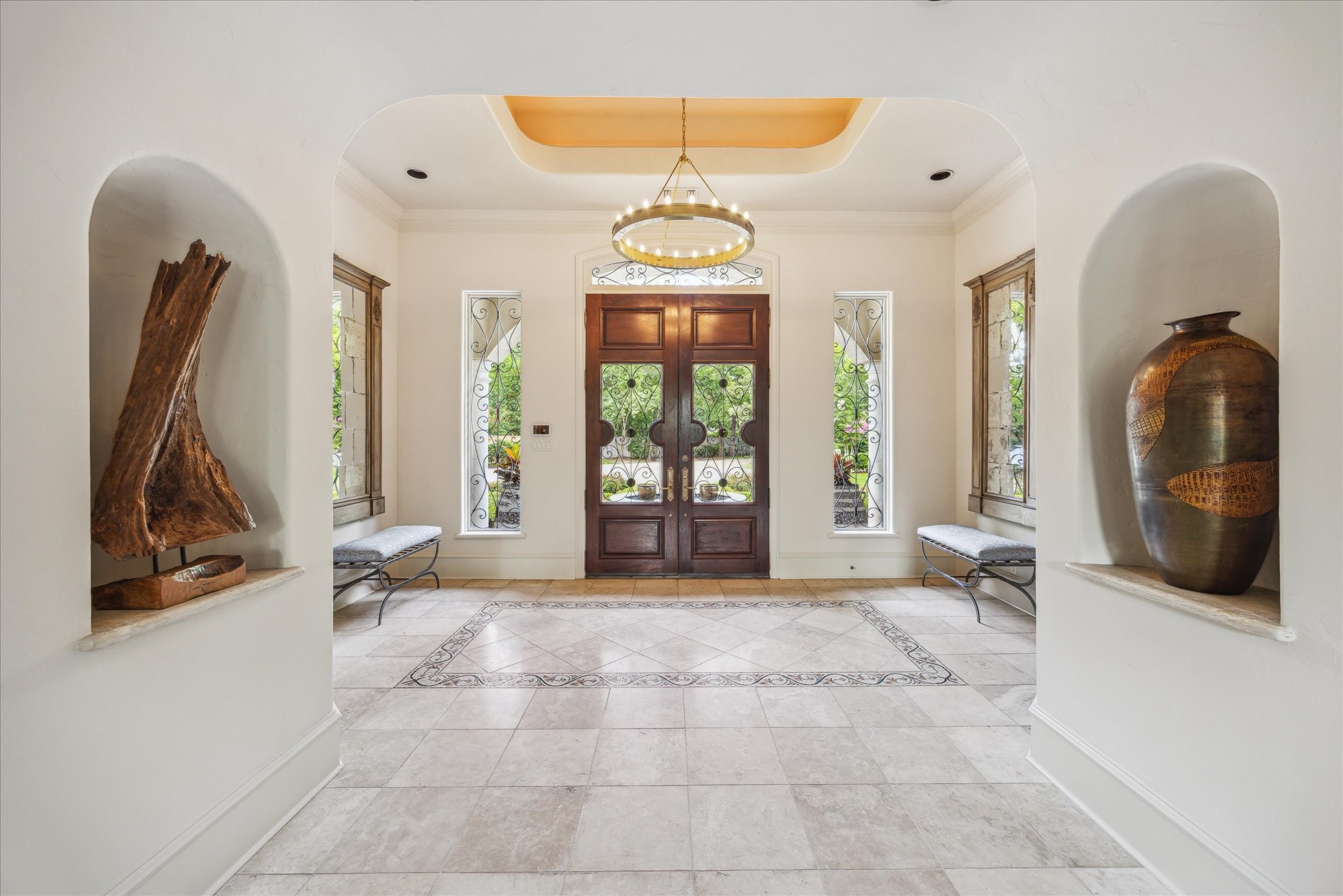 11607 Barazi Oaks Court Houston, TX 77024 - Photo 10 of 43 a view of a hallway with windows and chandelier