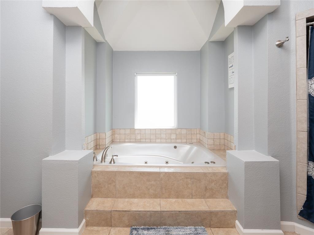 7321 North State Highway Blue Ridge, TX 75424 - Photo 27 of 30 Bathroom featuring a tub with jets, a textured wall, and tile patterned floors