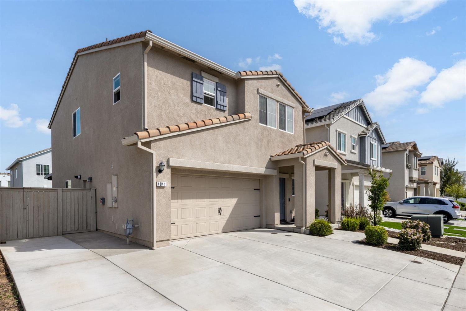 4041 Trailblazer Loop Roseville, CA 95747 - Photo 2 of 23 a front view of a house with large trees and cars parked in front of it