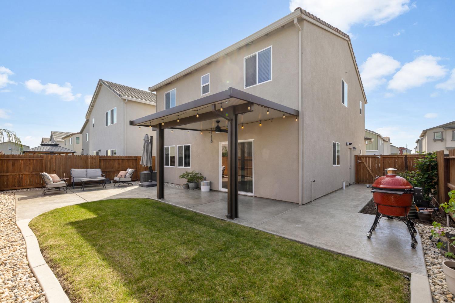 4041 Trailblazer Loop Roseville, CA 95747 - Photo 21 of 23 a view of a patio with table and chairs under an umbrella