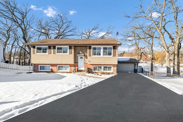 a front view of a house with a yard and a garage