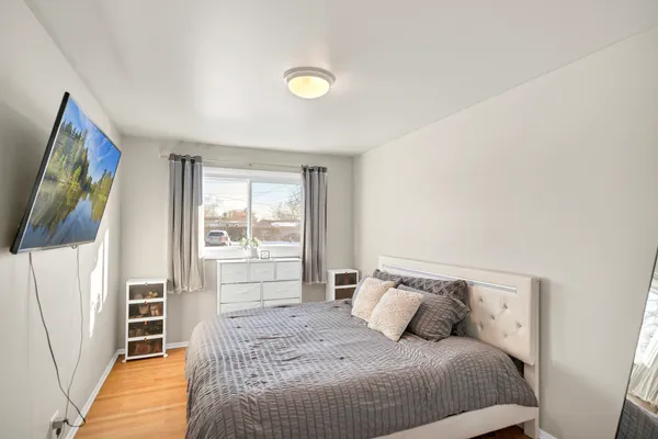 a bedroom with a bed and a flat screen tv