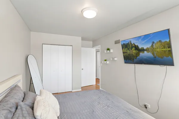 a view of a room with wooden floor and cabinet