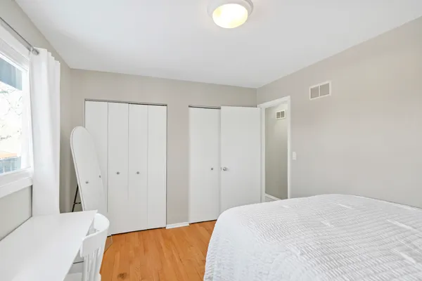a bedroom with a bed and a window