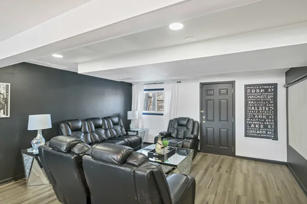 a living room with furniture and wooden floor