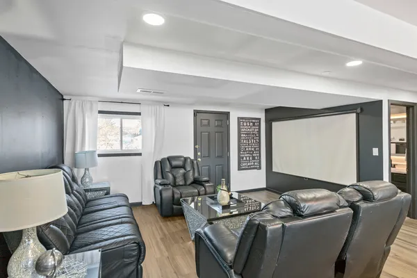 a living room with furniture a flat screen tv and a large window