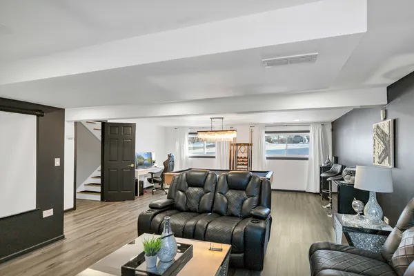 a living room with furniture and wooden floor