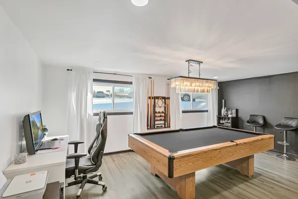 a living room with a table chairs and a flat screen tv
