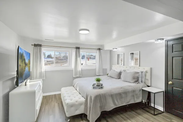 a bedroom with a bed and a flat screen tv