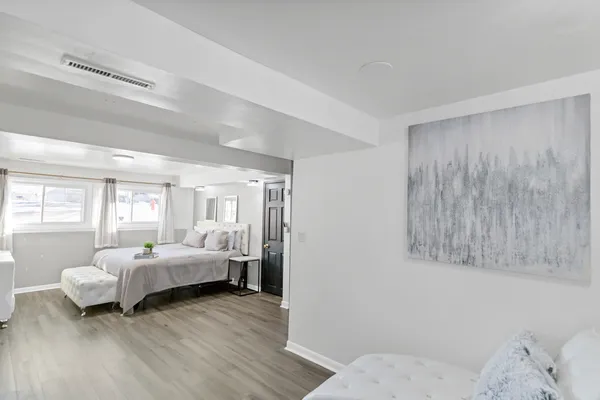 a bedroom with a bed and wooden floor