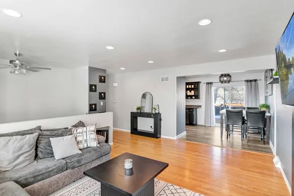 a living room with furniture and a wooden floor