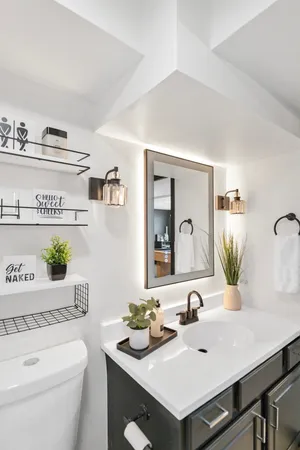 a bathroom with a sink a toilet and mirror
