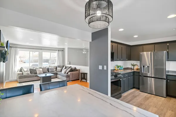 a kitchen with stainless steel appliances granite countertop a refrigerator and road