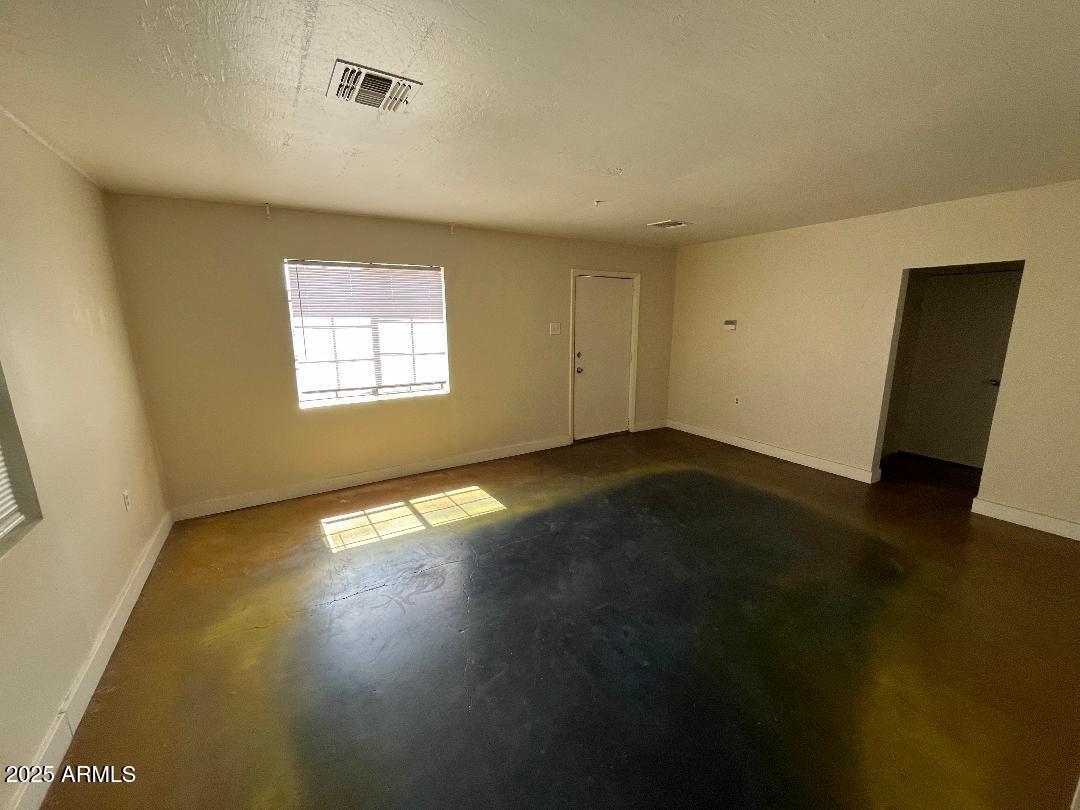 1006 East Weldon Avenue Phoenix, AZ 85014 - Photo 20 of 34 a view of an empty room with wooden floor and a window
