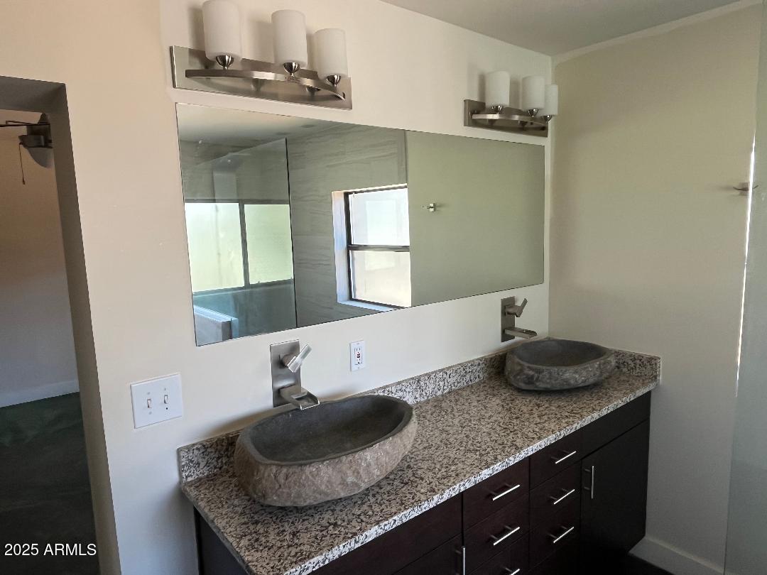 1006 East Weldon Avenue Phoenix, AZ 85014 - Photo 23 of 34 a bathroom with a granite countertop sink and a mirror