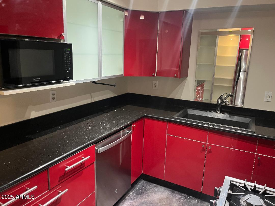 1006 East Weldon Avenue Phoenix, AZ 85014 - Photo 4 of 34 a kitchen with red cabinets and a microwave