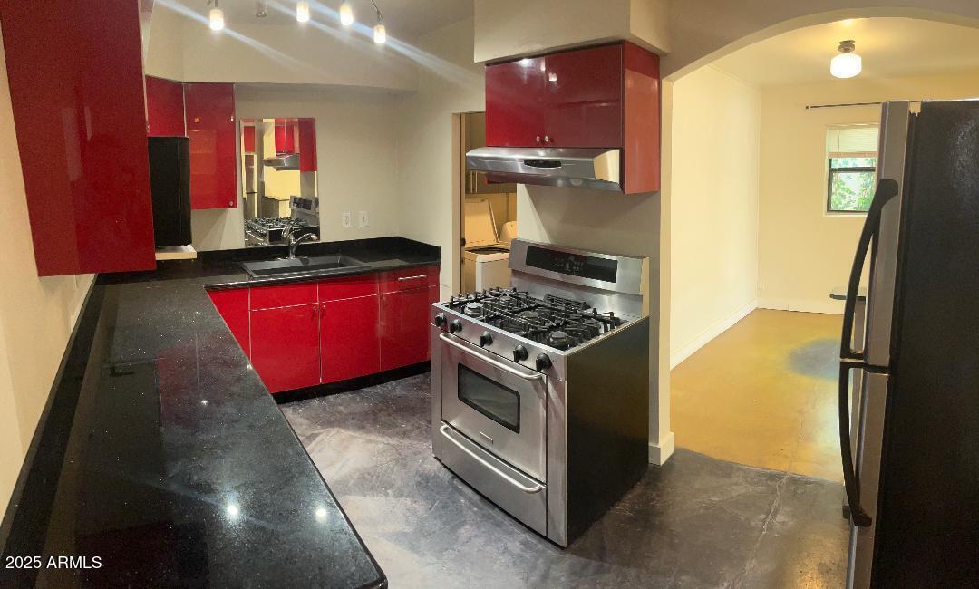 1006 East Weldon Avenue Phoenix, AZ 85014 - Photo 8 of 34 a kitchen with stainless steel appliances granite countertop a stove refrigerator and microwave