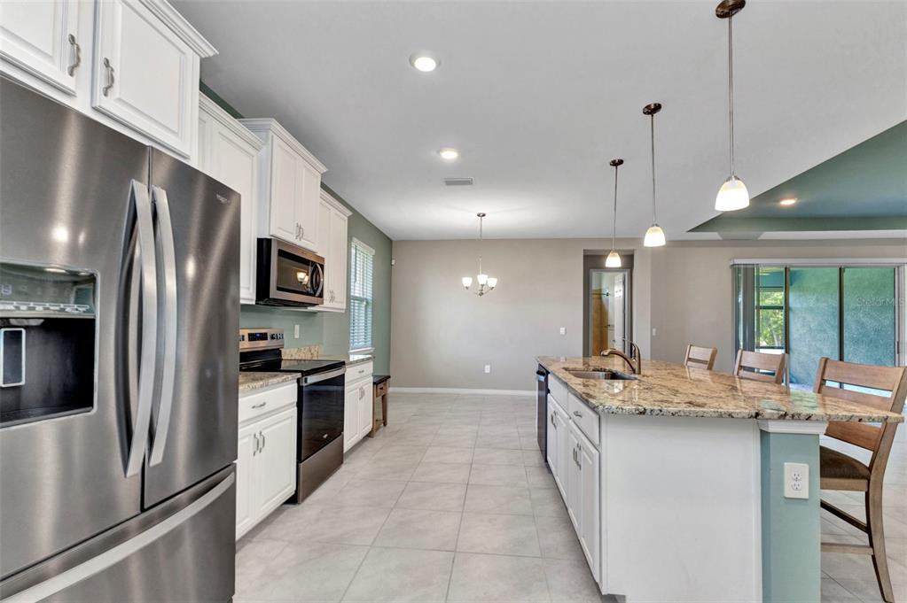 7028 North Plum Tree Punta Gorda, FL 33955 - Photo 3 of 57 a kitchen with stainless steel appliances granite countertop a sink a stove and a refrigerator