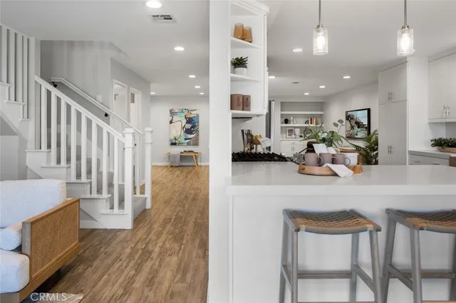 a bedroom with a bed and a painting on the wall