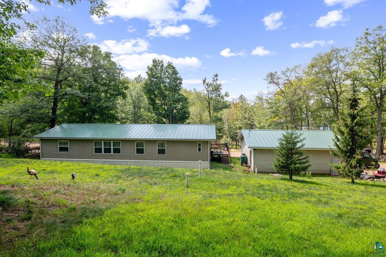 9505 Wildwood Campground Road Iron River, WI 54847 - Photo 20 of 34 Rear view of house with a lawn