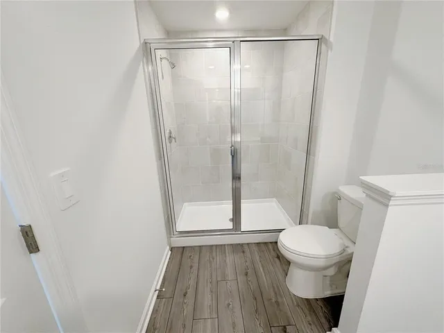 a bathroom with a toilet and a shower