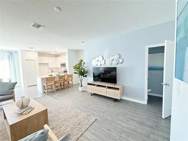 a kitchen with stainless steel appliances a refrigerator stove microwave and sink