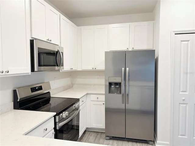 a kitchen with a refrigerator stove and microwave