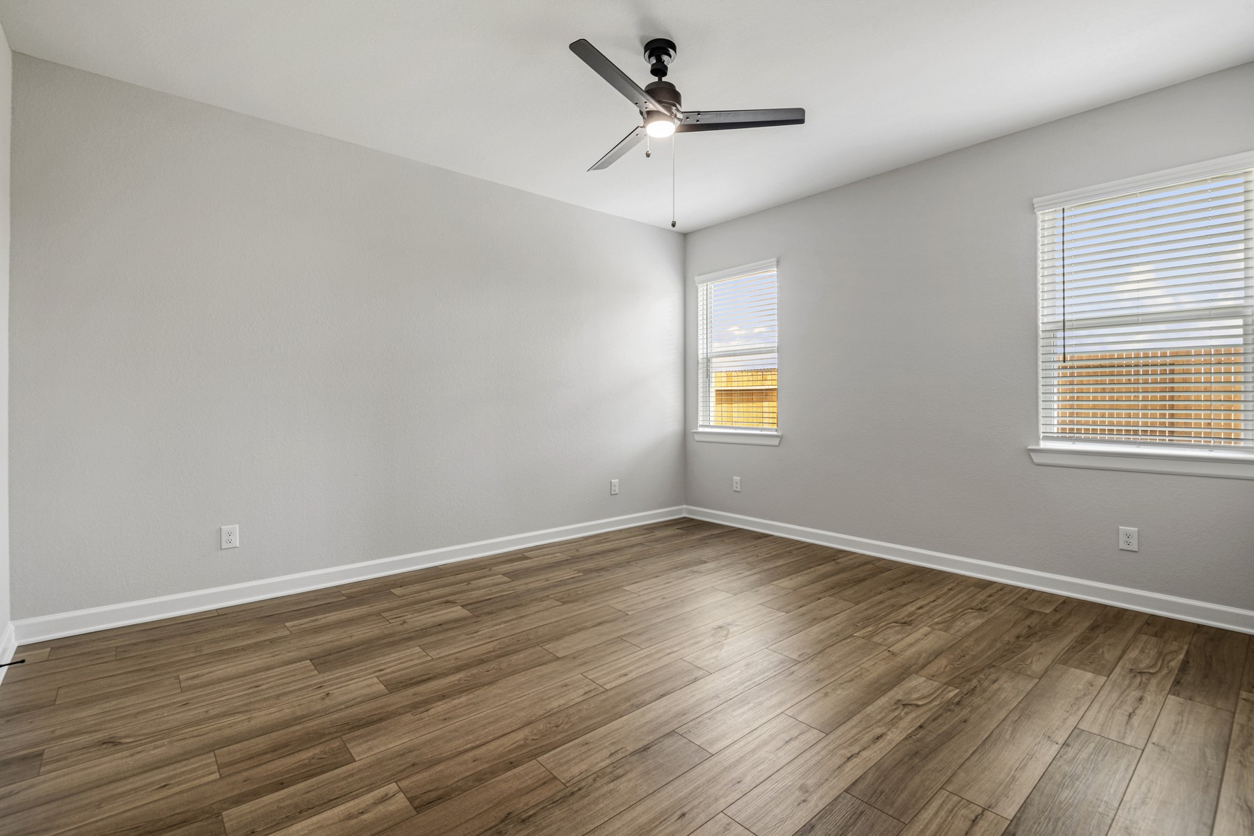 15683 Honey Cv Drive Conroe, TX 77303 - Photo 11 of 24 a view of an empty room with wooden floor and a window