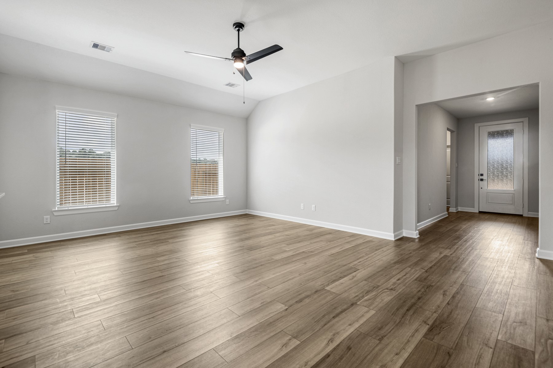 15683 Honey Cv Drive Conroe, TX 77303 - Photo 4 of 24 a view of empty room with wooden floor and window