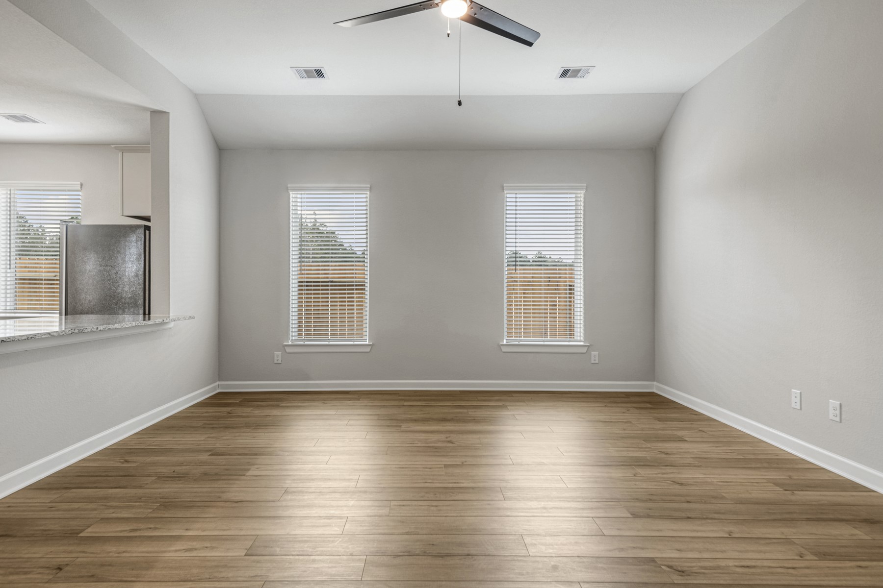 15683 Honey Cv Drive Conroe, TX 77303 - Photo 6 of 24 a view of an empty room with wooden floor and a window