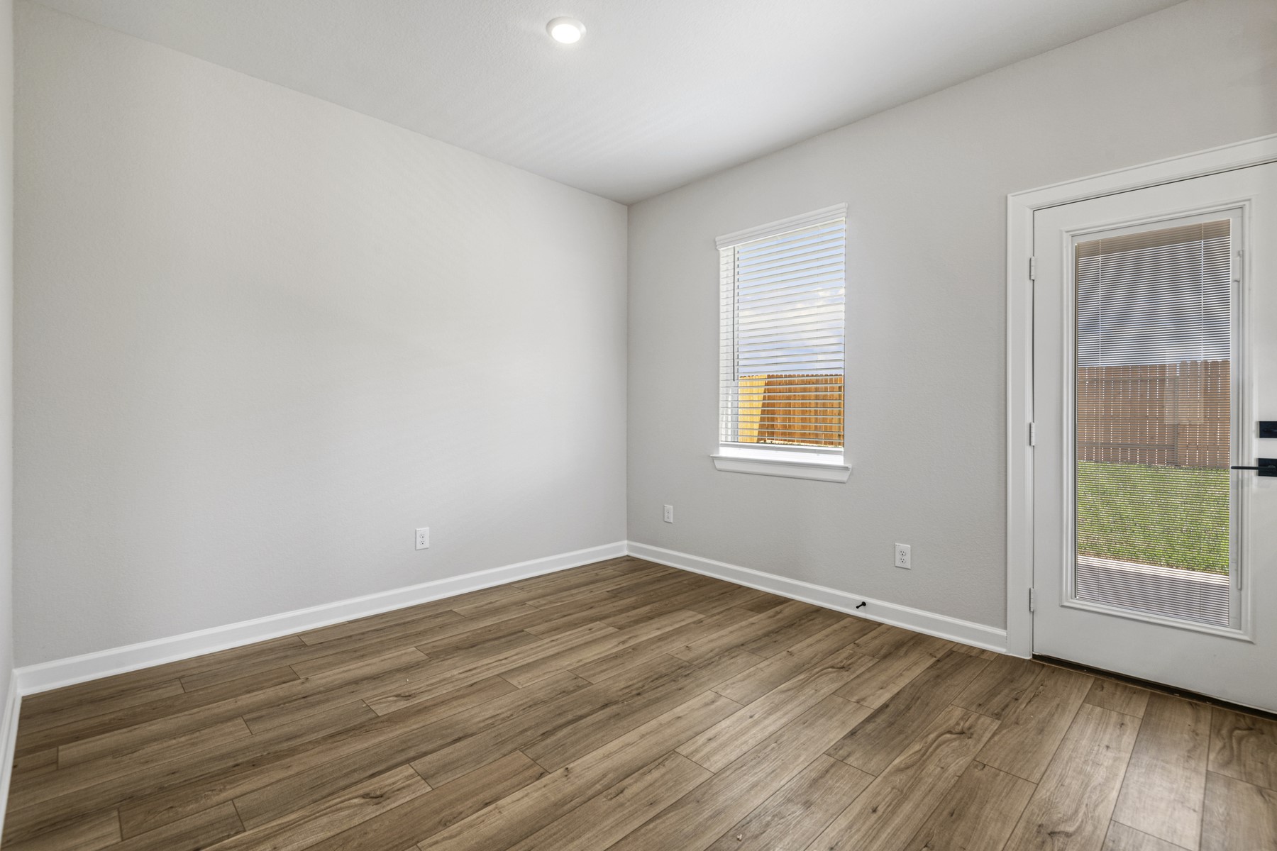 15683 Honey Cv Drive Conroe, TX 77303 - Photo 10 of 24 an empty room with wooden floor and windows