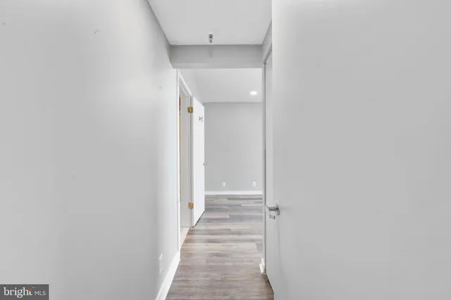 a view of a hallway with wooden floor