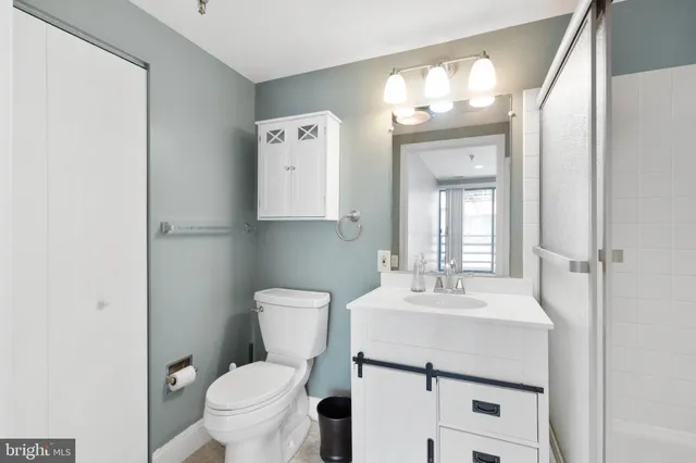 a bathroom with a toilet sink and mirror