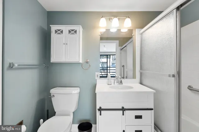 a bathroom with a sink mirror and toilet