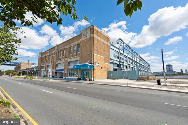 a view of a street with a building in the background