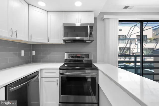 a kitchen with stainless steel appliances granite countertop a stove and a sink