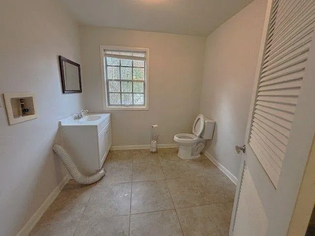 an empty room with fan and mirror