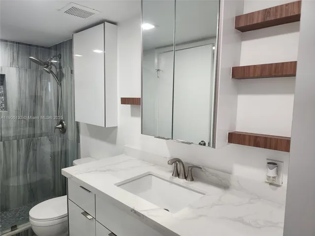 a view of a room with wooden floor and windows