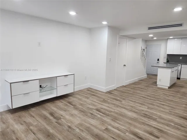 a view of a kitchen with wooden floor